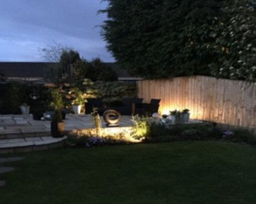 Garden and patio at dusk lit by LED spike lights